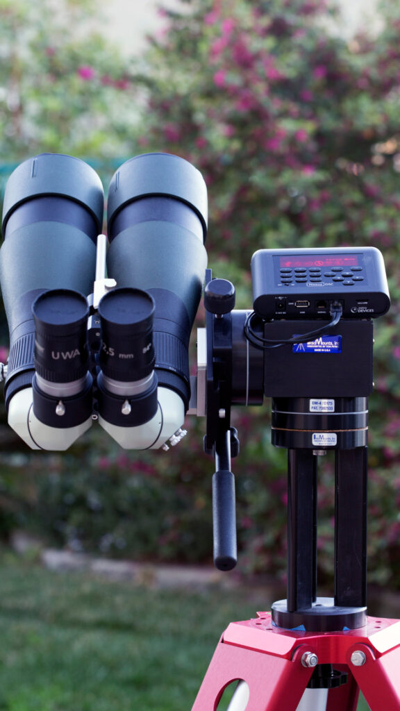 Nexus DSC Pro mounted on a pair of binoculars in someone's yard. Photo by Tamiji Homma.