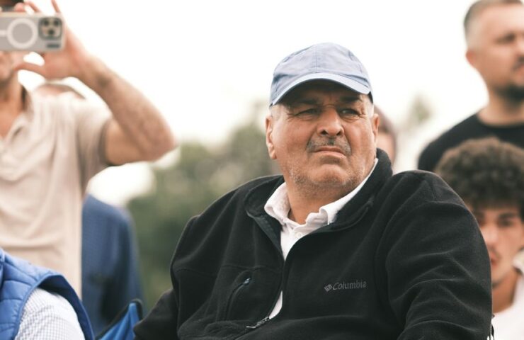 10 best products for older astronomers. An older man sits looking into the distance, surrounded by younger men in the background. He looks deep in thought.