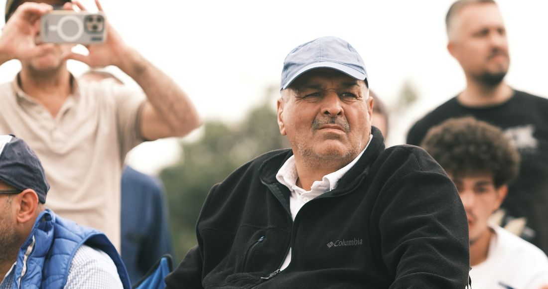 10 best products for older astronomers. An older man sits looking into the distance, surrounded by younger men in the background. He looks deep in thought.