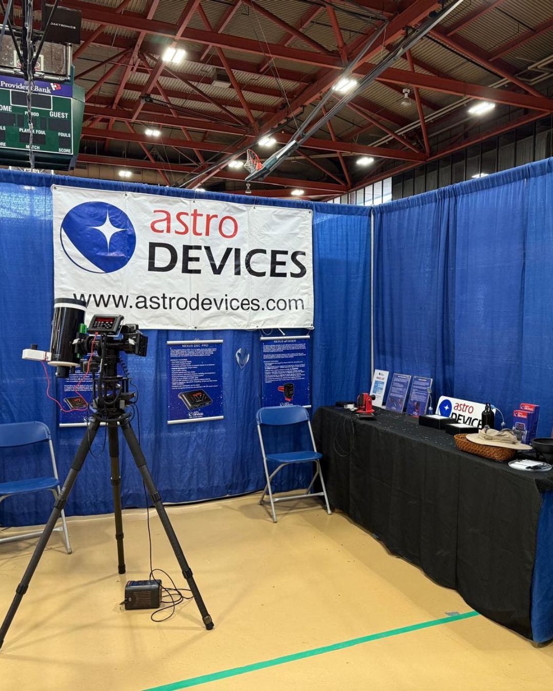 The Astro Devices booth at NEAF with a telescope on the left side sporting a Nexus DSC and Nexus eFinder